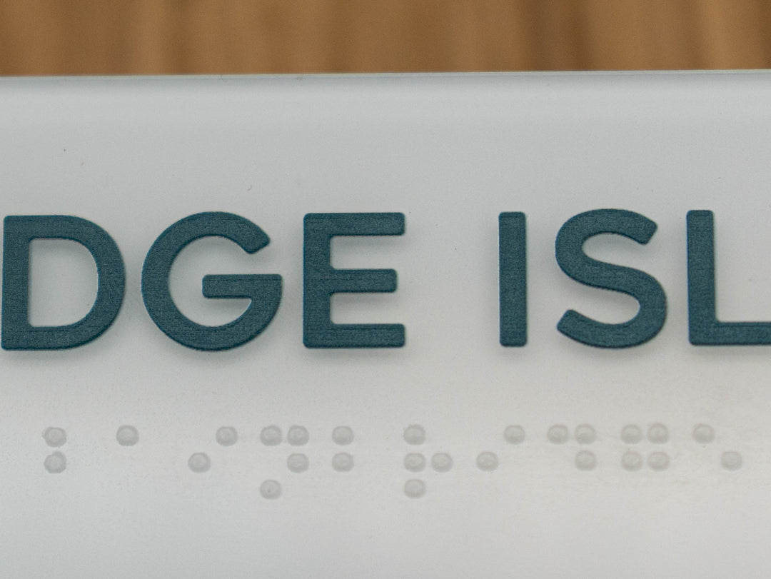 Custom edge painted interior sign with raised letters and ADA compliant Braille.