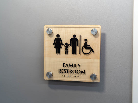 Custom raised transparent interior sign with raised letters and ADA compliant Braille.