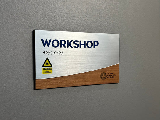 Custom Wood and metallic interior sign with raised letters and ADA compliant Braille.